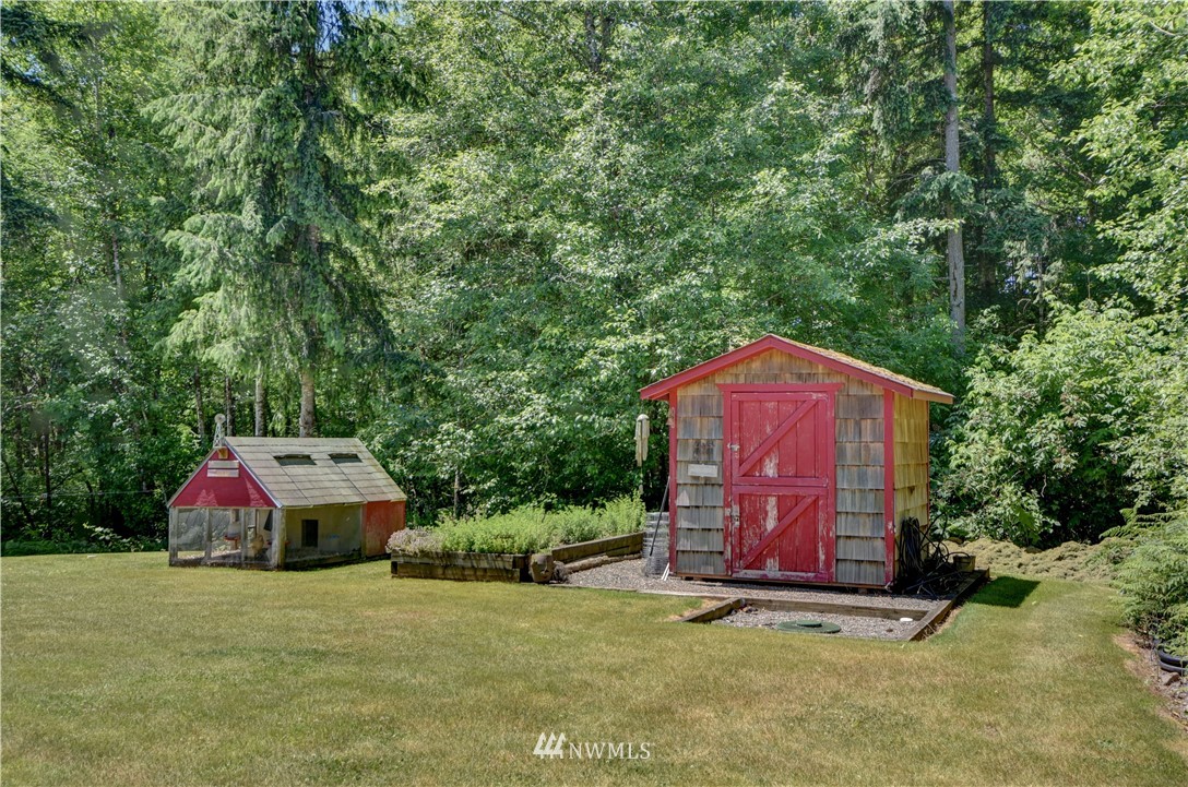15837 Case Road Southwest Rochester, WA 98579 - Photo 25 of 40 a view of a tiny house with a yard and large trees
