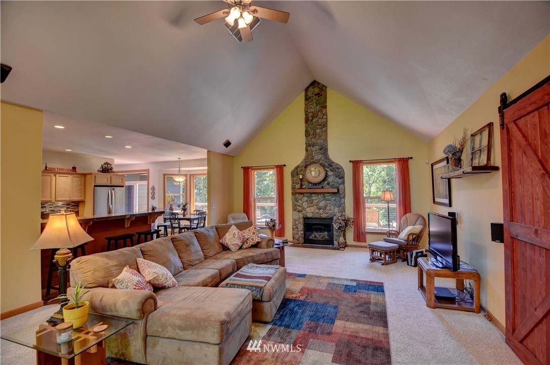 15837 Case Road Southwest Rochester, WA 98579 - Photo 4 of 40 a living room with furniture fireplace and a large window