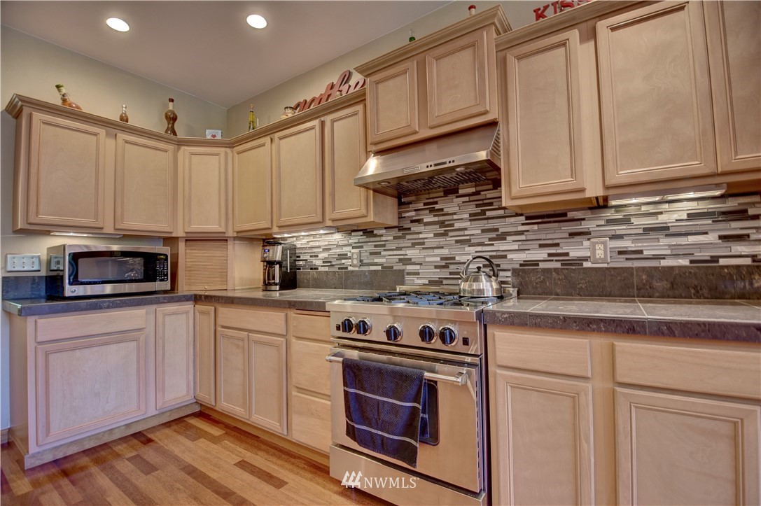 15837 Case Road Southwest Rochester, WA 98579 - Photo 8 of 40 a kitchen with stainless steel appliances granite countertop a sink a stove and cabinets