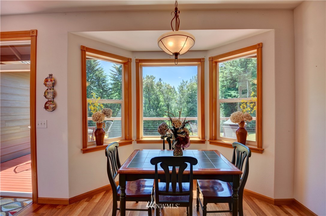 15837 Case Road Southwest Rochester, WA 98579 - Photo 10 of 40 a view of a dining room with furniture window and wooden floor