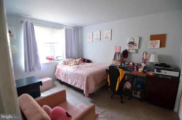 a bedroom with a bed dresser and a window