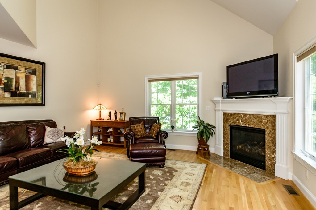 24 Overlook Drive Bedford, MA 01730 - Photo 13 of 30 a living room with furniture a fireplace and a flat screen tv