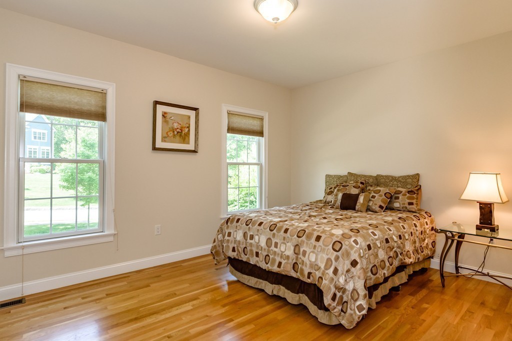 24 Overlook Drive Bedford, MA 01730 - Photo 15 of 30 a bedroom with a bed a lamp and a window