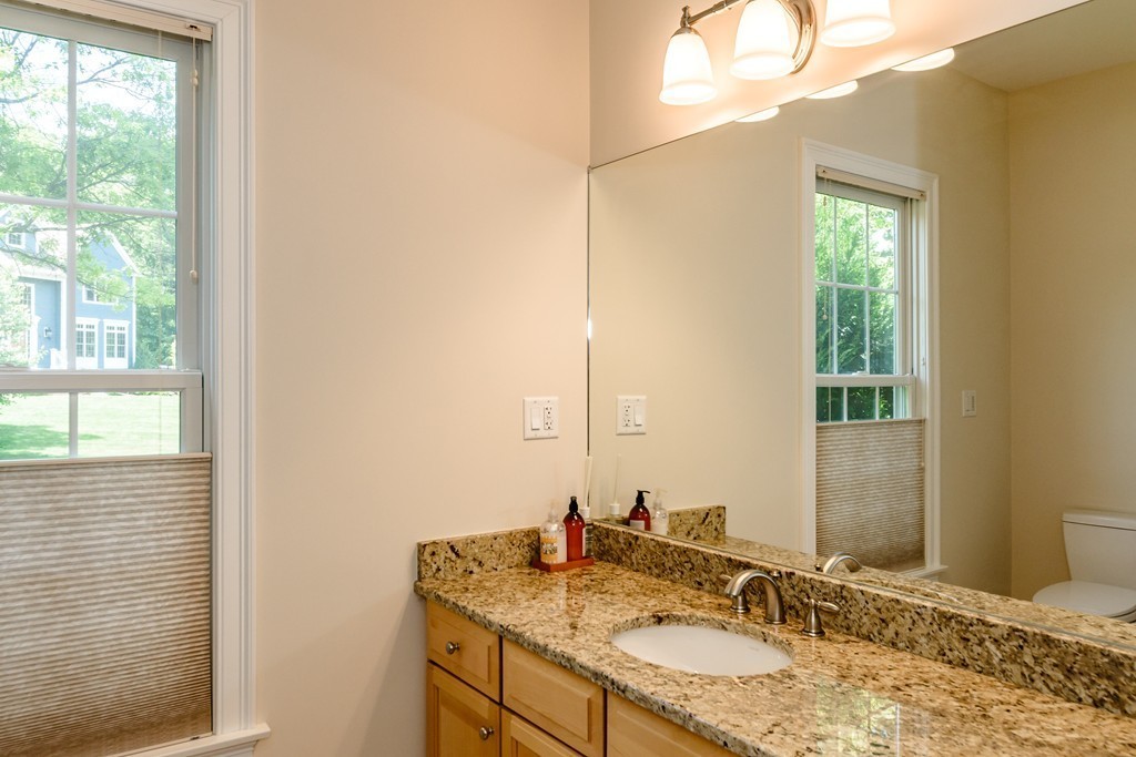 24 Overlook Drive Bedford, MA 01730 - Photo 16 of 30 a bathroom with a granite countertop sink and a mirror