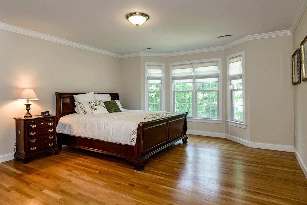 24 Overlook Drive Bedford, MA 01730 - Photo 18 of 30 a large bed sitting in a bedroom next to a window