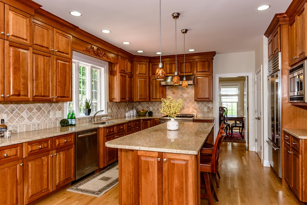 24 Overlook Drive Bedford, MA 01730 - Photo 9 of 30 a kitchen with stainless steel appliances granite countertop a sink a stove and a refrigerator