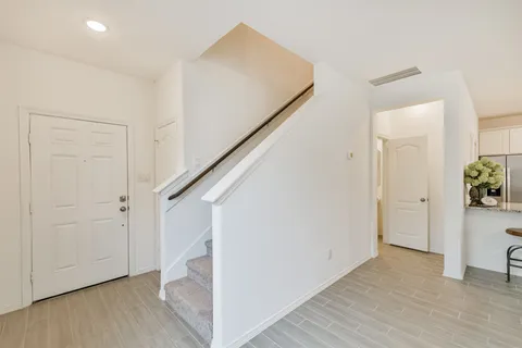 a view of an entryway with wooden floor