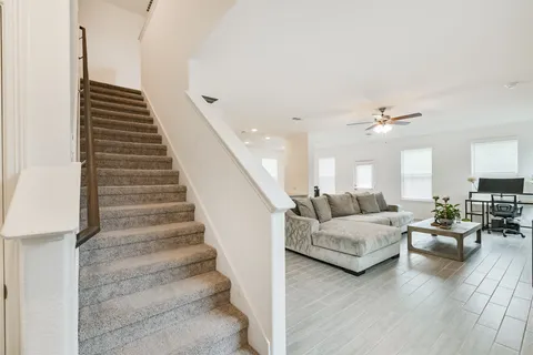 a living room with furniture and a chandelier