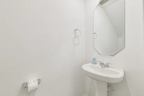 a bathroom with a sink a mirror and shower curtain