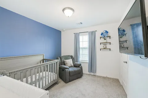 a bedroom with furniture and wooden floor