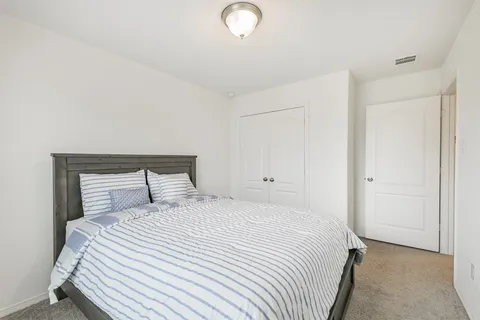 a bedroom with a bed and a lamp