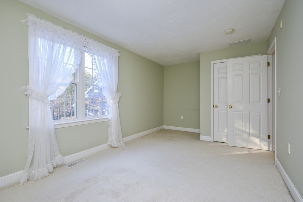 14 Stratford Ridge, Unit 14 Mashpee, MA 02649 - Photo 14 of 23 an empty room with windows and closet