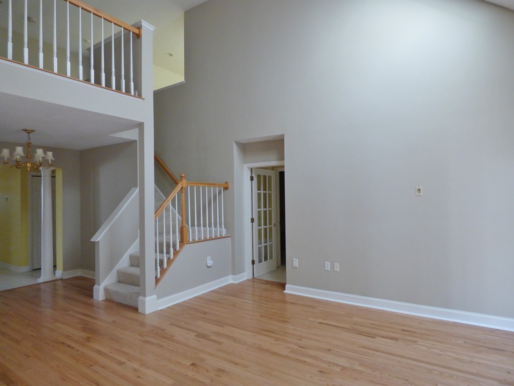 14 Stratford Ridge, Unit 14 Mashpee, MA 02649 - Photo 5 of 23 a view of a hallway with wooden floor and staircase