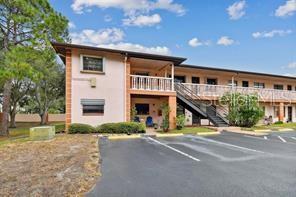 13250 Ridge Road, Unit 3B1 Largo, FL 33778 - Photo 1 of 15 a front view of a house with a yard and garage