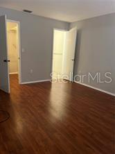 13250 Ridge Road, Unit 3B1 Largo, FL 33778 - Photo 11 of 15 a view of an empty room with wooden floor and a window