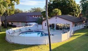 13250 Ridge Road, Unit 3B1 Largo, FL 33778 - Photo 13 of 15 a swimming pool with outdoor seating and yard