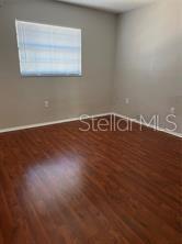 13250 Ridge Road, Unit 3B1 Largo, FL 33778 - Photo 9 of 15 a view of room with wooden floor