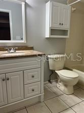 13250 Ridge Road, Unit 3B1 Largo, FL 33778 - Photo 10 of 15 a bathroom with a sink a toilet and cabinets