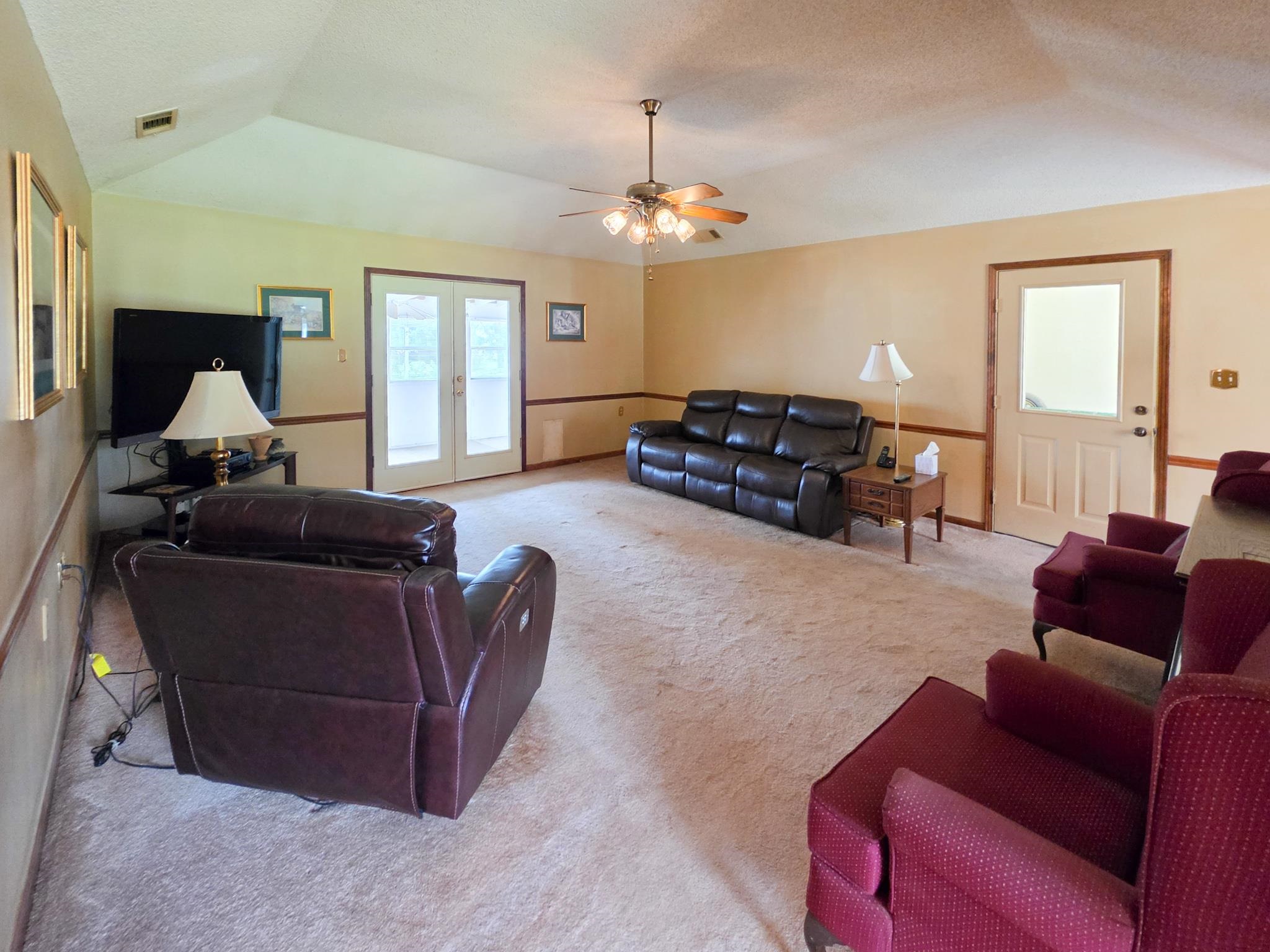 966 Beaver Road Munford, TN 38058 - Photo 4 of 32 Spacious living area featuring vaulted ceilings, a ceiling fan with integrated lighting, and neutral carpeting