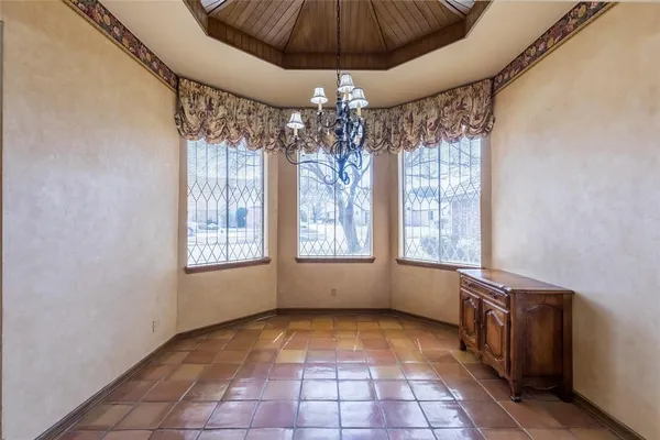 a view of a room with window and chandelier