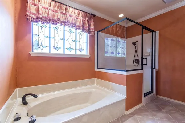 a bathroom with a tub and a shower