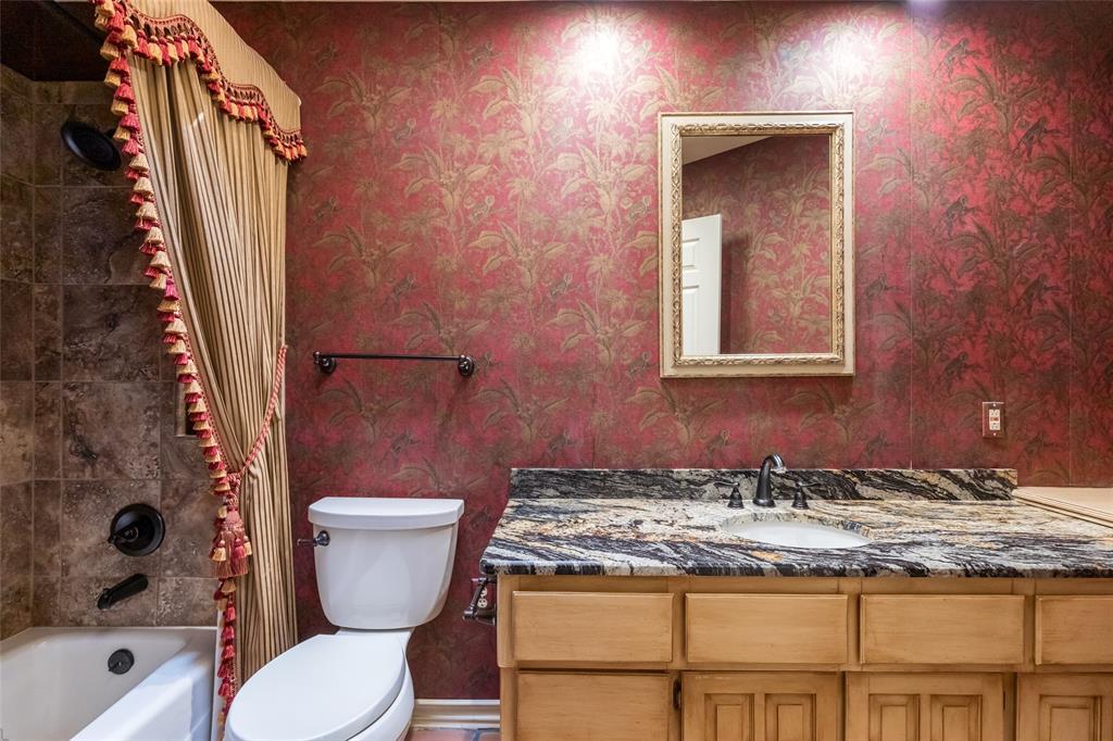 50 Riviera Circle Abilene, TX 79606 - Photo 27 of 40 a bathroom with a granite countertop toilet and a sink