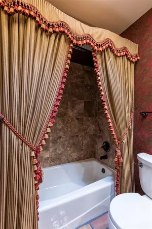 a bathroom with a toilet and a bathtub