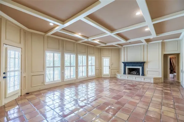 a view of an empty room with a fireplace and a window