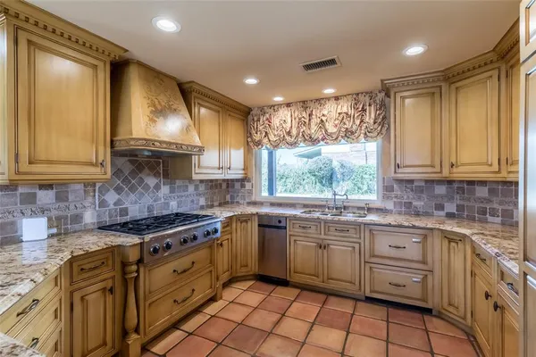 a kitchen with a sink stove and cabinets
