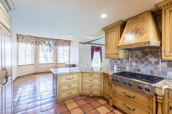 a kitchen with granite countertop a stove and a wooden floors