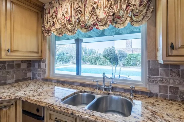 a kitchen with a sink and a window