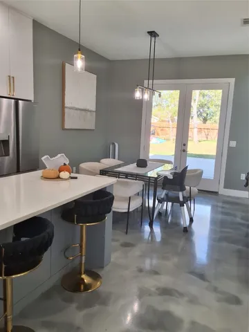 a view of a dining room with furniture and window