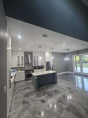 a large white kitchen with a large window
