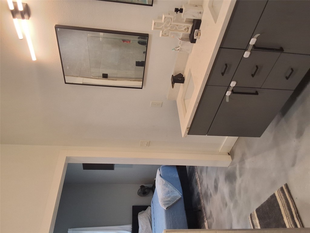 724 Ramsey Avenue Rockdale, TX 76567 - Photo 18 of 36 a en suite bathroom with a double vanity sink and a mirror