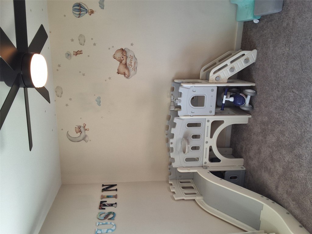 724 Ramsey Avenue Rockdale, TX 76567 - Photo 21 of 36 a bedroom with a bed and a table