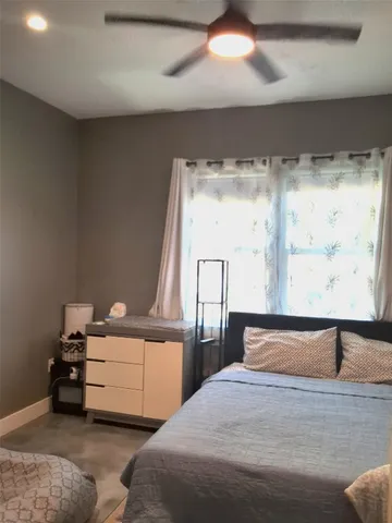 a bedroom with a bed and window