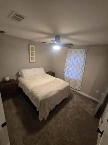 a bedroom with a bed and a night stand