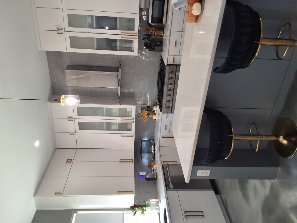 724 Ramsey Avenue Rockdale, TX 76567 - Photo 7 of 36 a kitchen with stainless steel appliances a sink a stove a refrigerator and cabinets