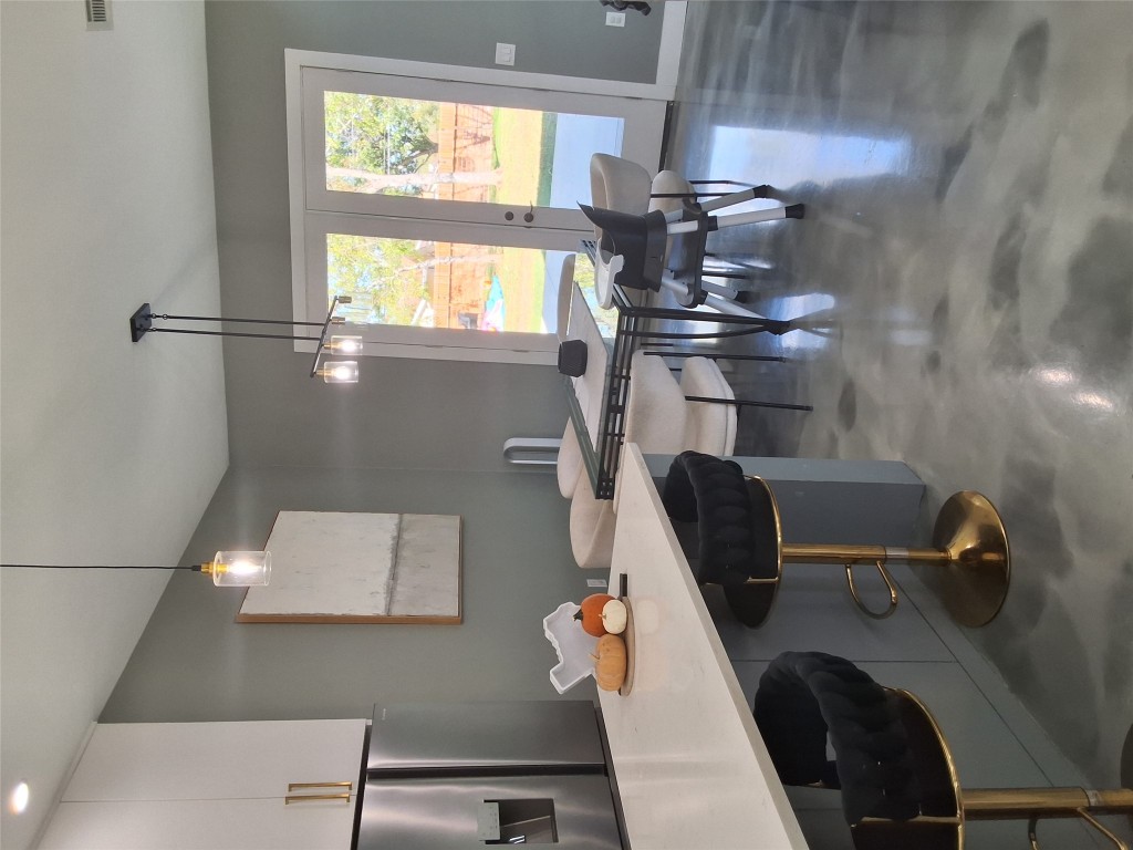 724 Ramsey Avenue Rockdale, TX 76567 - Photo 10 of 36 a view of a dining room with furniture window and wooden floor