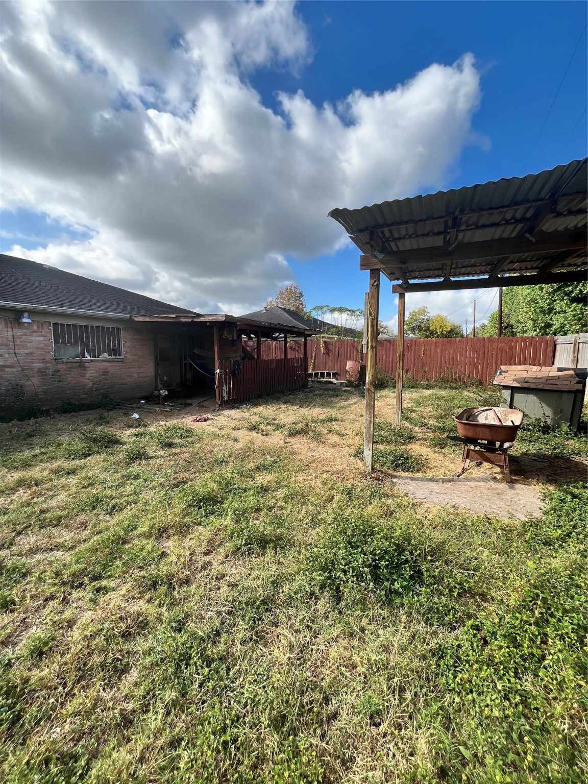 4306 Kelling Street Houston, TX 77045 - Photo 4 of 15 a view of a patio with table and chairs under an umbrella
