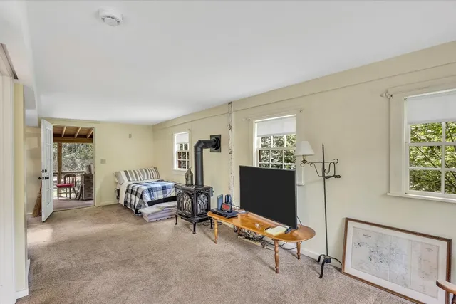 a view of a livingroom with workspace and a window