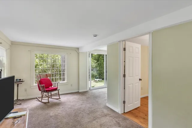 a living room with furniture and floor to ceiling windows