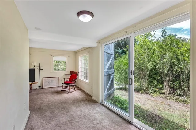 a view of a livingroom with workspace and a window