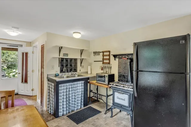 a kitchen with stainless steel appliances a sink cabinets and a refrigerator