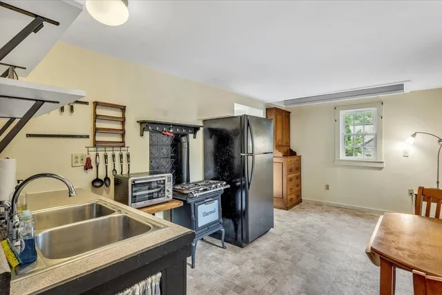 a kitchen with a refrigerator a stove top oven a sink and dishwasher