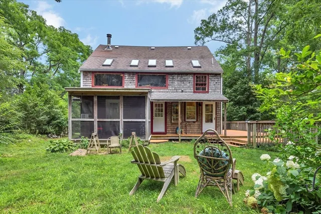 a front view of a house with a yard table and chairs