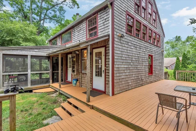 a view of a house with backyard and sitting area