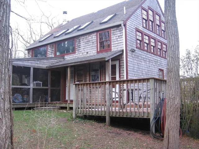 a view of a house with a large window and a yard