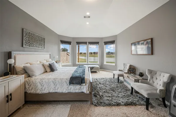 a bedroom with a bed and glass window