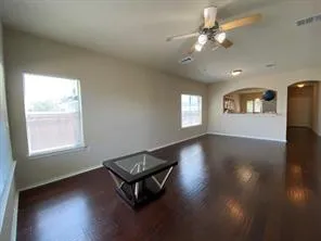 a living room with hardwood floor and a window
